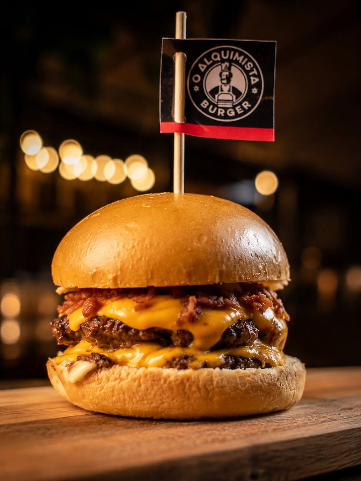 Smash burger with bacon and cheddar on a wooden board
